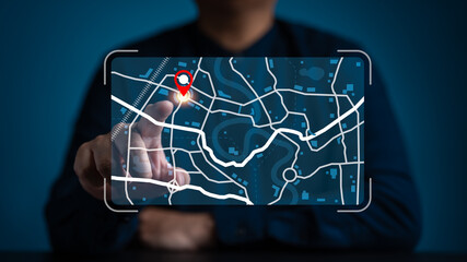 Businessman pointing at a digital map interface with a red location pin. Concept for GPS...