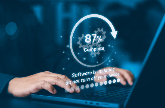 Person working on laptop with software update progress bar showing 87 percent complete. Concept for system upgrade, digital transformation, data loading, and futuristic technology maintenance. - Powered by Adobe