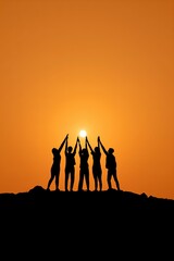 Silhouetted group at sunset holding sun on hilltop