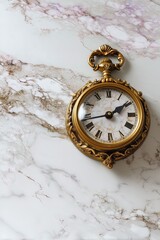 Elegant vintage pocket watch in ornate gold case on marble surface