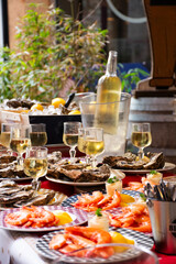 table of prawns and oysters and white wine on the street of lyon