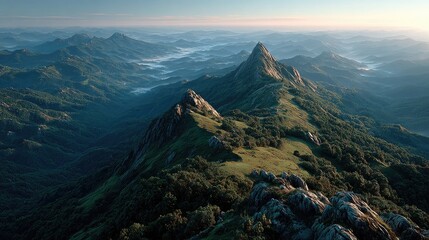 Misty mountain range at dawn. Lush greenery, rocky peaks