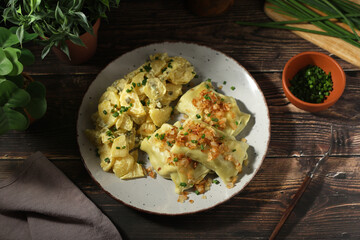 Traditional Swabian dish Maultaschen served with roasted onion and potato salad