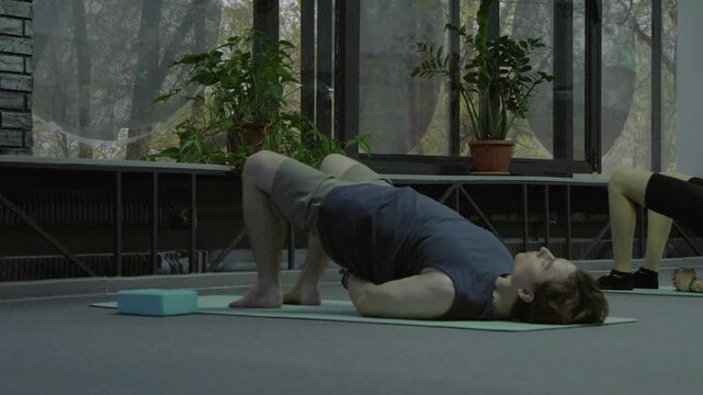 Group practicing standing backbend and twists in class.