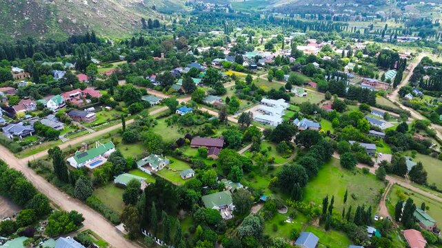 High-angle point of view of the centre of Clarens, South Africa, camera panning up to the Maluti Mountains in the background 4K Aerial Video