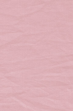 Natural pastel pink linen cotton blend vintage chinos trousers texture, large vertical macro closeup, rustic wrinkled crumpled textured burlap background, horizontal light canvas pattern fabric swatch
