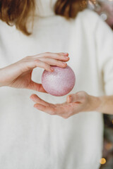 Woman Holding Pink Glitter Christmas Ornament