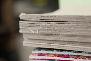 Stack of paper sheets on a table in a workspace