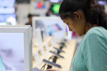 Woman shopping for tech products in store