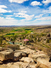 panoramic shot of rugged beauty of Bayanaul, Kazakhstan. A pathway with railings and small gazebos. For travel brochures, tourism websites, nature documentaries, promotional materials about Kazakhstan