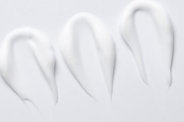 A sample of a white moisturizing cosmetic cream for the body or face with hyaluronic acid