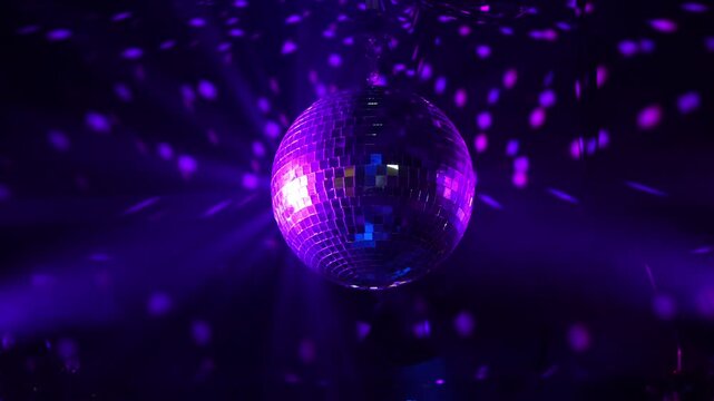 mirror disco ball in neon light in a nightclub