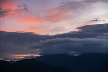 Fototapeta premium Dramatic sunset clouds after storm over the silhouette mountains .