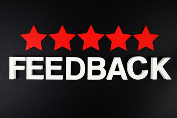 Feedback alphabet letters with fife red star on black background