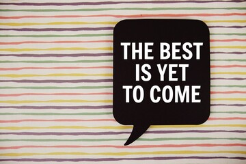 The Best Is Yet to Come text with speech bubble top view on colorful stripes background
