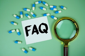 FAQ with medicine capsule and magnifying glass on green background