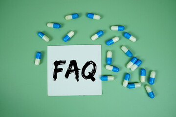 FAQ with medicine capsule on green background