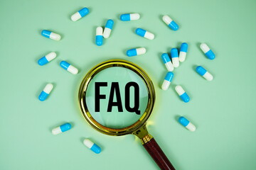 FAQ with medicine capsule and magnifying glass on green background
