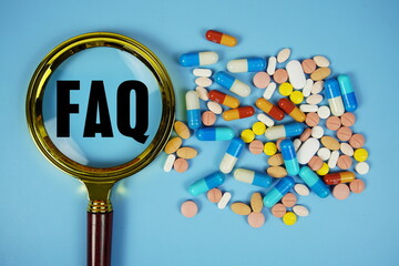 FAQ with Various Colored Pills and magnifying glass on blue background