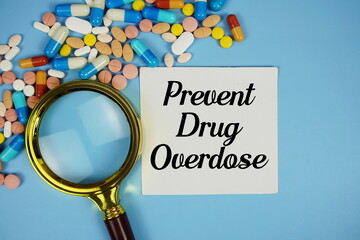 Prevent Drug Overdose with Various Colored Pills and magnifying glass on blue background