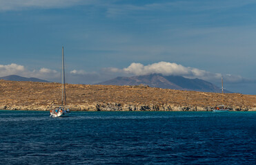 Sailboat on Deep Blue Sea Along Rocky Mediterranean Coast