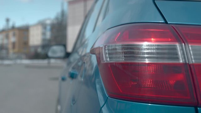 Person Opening Car Trunk In City Scene, Winter Scene With Vehicle And Pedestrian In Urban Environment. Media