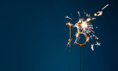 15 years anniversary celebration festive background with copy space made with Bengal fires in the form of number Fifteen.