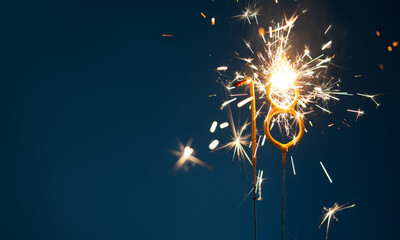 18 years celebration festive background with copy space made with Bengal fires in the form of number Eighteen.