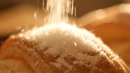 Sprinkling sugar on pastry
