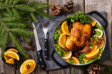 Whole roasted chicken in baking dish with citrus