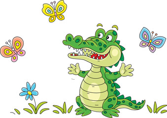 Happy green crocodile playing with colorful butterflies on a summer lawn with flowers, vector cartoon illustration on a white background