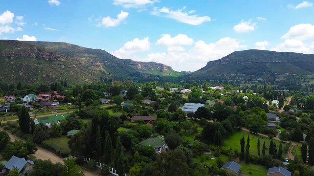 Camera rising up close-up view of the town centre of Clarens South Africa with the Maluti Mountains in the background. 4K Aerial Video.