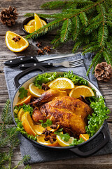 Whole roasted chicken in baking dish with citrus
