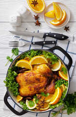 Whole roasted chicken in baking dish with citrus