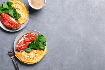 Healthy breakfast for two. Omelette, sandwich with salmon, spinach.