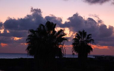 Spectacular sunset at Coral Bay offers a direct view of the sun setting over the Mediterranean Sea
