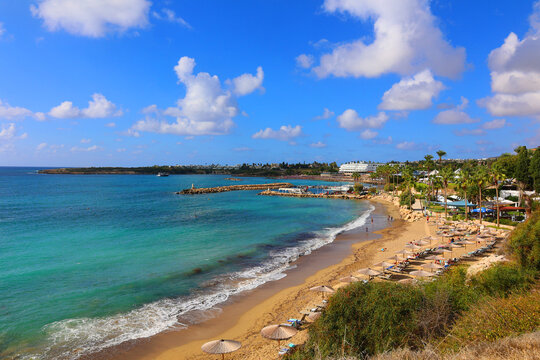 Coral Bay is a crescent-shaped beach near Paphos known for its soft, golden sand and calm, shallow waters, which make it ideal for families and swimming