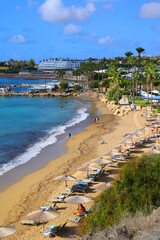 Obraz premium Coral Bay is a crescent-shaped beach near Paphos known for its soft, golden sand and calm, shallow waters, which make it ideal for families and swimming