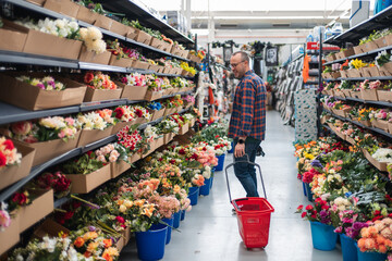 Man shopping artificial flowers for craft project