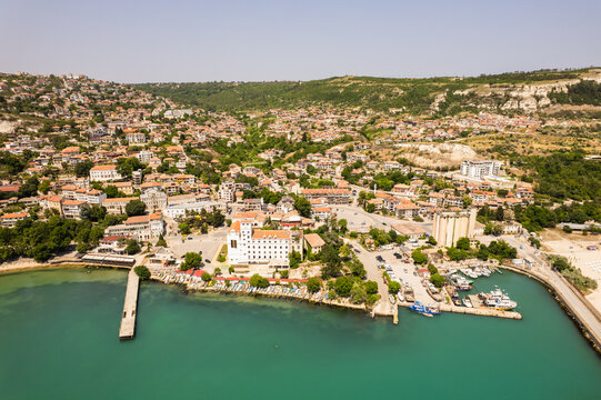 Aerial view of the serene harbor embracing the old town, where terracotta roofs meet the turquoise sea, Balchik, Dobrich Province, Bulgaria.
