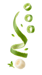 Fresh green onion slices and curled green onion leaves falling, isolated on white background, perfect for healthy recipes and cooking blogs