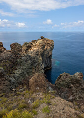 Dramatic volcanic cliffs at Alagoa Viewpoint overlooking the deep blue Atlantic Ocean on Terceira Island, Azores, Portugal, showcasing rugged lava coast scenery and natural beauty