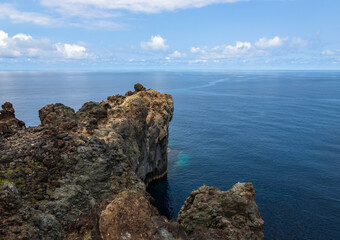 Dramatic volcanic cliffs at Alagoa Viewpoint overlooking the deep blue Atlantic Ocean on Terceira Island, Azores, Portugal, showcasing rugged lava coast scenery and natural beauty