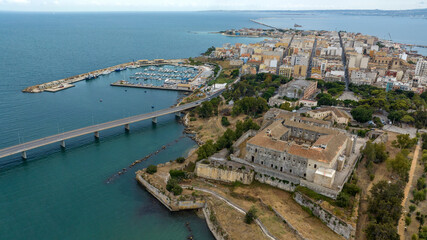 Obraz premium Aerial view of the town of Augusta, in the province of Syracuse, Sicily, Italy. The historic centre is built on an island overlooking the Mediterranean Sea. In the foreground is the Swabian castle.