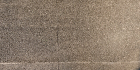 view from above on texture of asphalt road surface with cracks