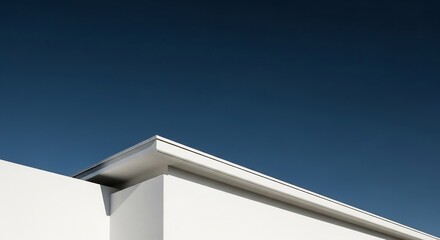 White geometric building corner against a deep blue sky