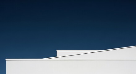 White geometric shapes against a dark blue sky