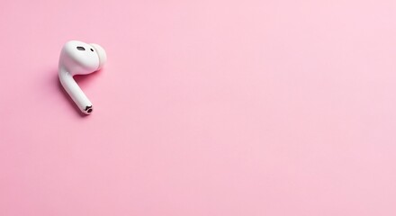 White wireless earbud on a pink background