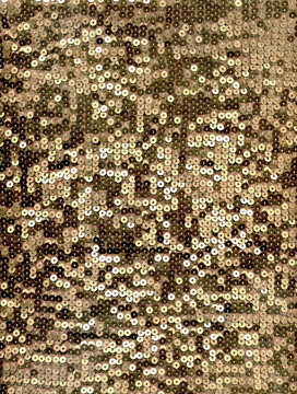 Gold sequin fabric texture with sparkling metallic discs, luxurious glitter background ideal for festive decor, holiday design, fashion, glamorous branding.