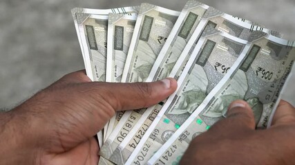 Indian currency counts income from small business and financial investments. Indian 500 rupees close up. - Powered by Adobe